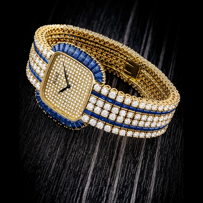 PIAGET. AN IMPRESSIVE 18K GOLD, SAPPHIRE AND DIAMOND-SET BRACELET WATCH MANUFACTURED IN 1988