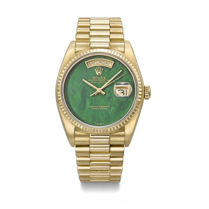 Rolex ROLEX. A RARE AND ATTRACTIVE 18K GOLD AUTOMATIC WRISTWATCH WITH SWEEP CENTRE SECONDS, DAY, DATE, GREEN BLOODSTONE DIAL AND BRACELET SIGNED ROLEX, DAY-DATE MODEL, REF. 18038, CASE NO. 8'049'373, CIRCA 1983, Price & Market Data