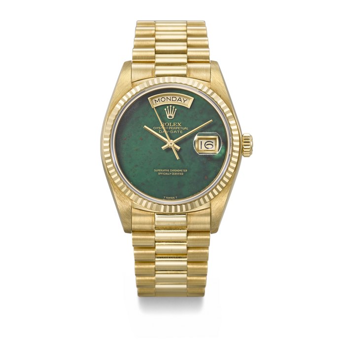 ROLEX. A VERY RARE AND HIGHLY IMPORTANT 18K GOLD AUTOMATIC WRISTWATCH WITH SWEEP CENTRE SECONDS, DAY , DATE , GREEN JASPER BLOODSTONE DIAL, BRACELET AND MATCHING PAIR OF CHAUMET CUFFLINKS, ORDERED BY HIS MAJESTY KING HASSAN II SIGNED ROLEX, DAY-DATE MODEL, RETAILED BY CHAUMET, REF. 18038, CASE NO. 5’600’115, CHAUMET NO. 2688RE, CIRCA 1978, SOLD TO HIS MAJESTY KING HASSAN II OF MOROCCO ON 10 NOVEMBER 1979