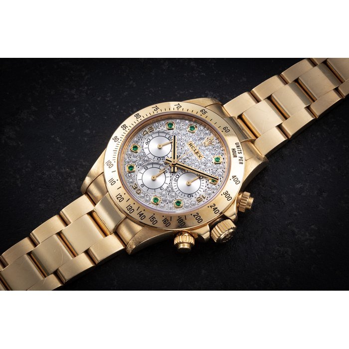 Rolex ROLEX, DAYTONA REF. 16528, AN ATTRACTIVE AND RARE GOLD AUTOMATIC CHRONOGRAPH WITH DIAMOND AND EMERALD-SET DIAL CASE NUMBER: U356'XXX · 16528
