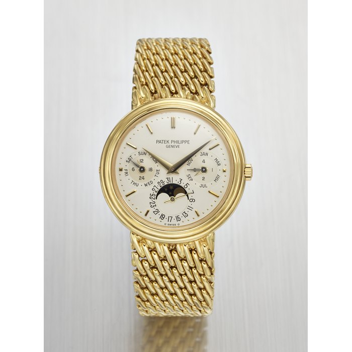 PATEK PHILIPPE. A RARE AND ELEGANT 18K GOLD AUTOMATIC PERPETUAL CALENDAR WRISTWATCH WITH MOON PHASES, 24 HOUR, LEAP YEAR INDICATION AND BRACELET SIGNED PATEK PHILIPPE, GENEVE, REF. 3945/1, MOVEMENT NO. 770'795, CASE NO. 2'838'717, CIRCA 1987