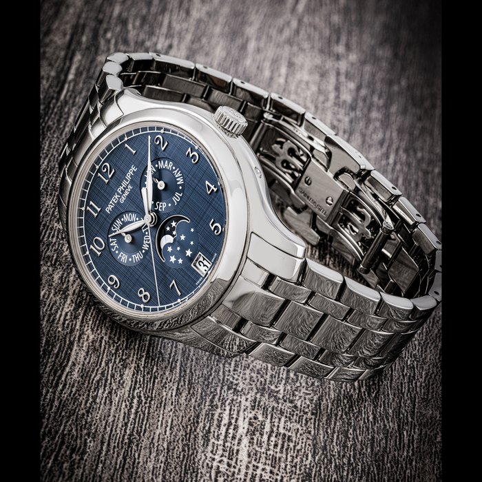 PATEK PHILIPPE. A LADY’S ATTRACTIVE STAINLESS STEEL AUTOMATIC ANNUAL CALENDAR WRISTWATCH WITH SWEEP CENTRE SECONDS, MOON PHASES AND BRACELET REF. 4947/1A-001, CIRCA 2021