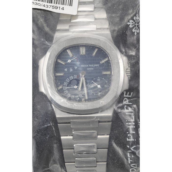 PATEK PHILIPPE. A VERY RARE STAINLESS STEEL AUTOMATIC WRISTWATCH WITH DATE, MOON PHASES, POWER RESERVE AND BRACELET SIGNED PATEK PHILIPPE, GENEVE, RETAILED BY TIFFANY & CO., NAUTILUS MODEL, REF. 5712/1A-001, MOVEMENT NO. 3'173'630, CASE NO. 4'375'914, CIRCA 2008