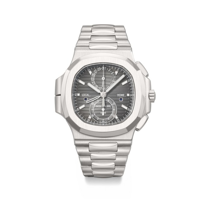 PATEK PHILIPPE. A COVETED AND LARGE STAINLESS STEEL AUTOMATIC FLYBACK CHRONOGRAPH DUAL TIME WRISTWATCH WITH DAY/NIGHT INDICATOR, DATE AND BRACELET SIGNED PATEK PHILIPPE, NAUTILUS MODEL, REF. 5990/1A-001, MOVEMENT NO. 5'854'922, CASE NO. 4'699'254, CIRCA 2015