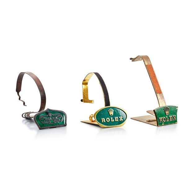 Rolex A set of three gilt brass and green enamel watch stands, Circa 1950 | 勞力士 一套三件鍍金銅製鑲綠琺瑯展示座，約1950年製