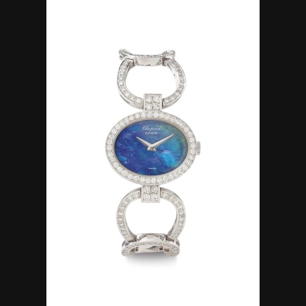 Chopard. A Lady's 18K White Gold, Diamond and Opal Oval-shaped Bangle-Watch SIGNED CHOPARD, CASE NOS. 77379, 5050 AND G2922, CIRCA 1995