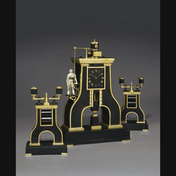 A French Brass A French brass, patinated brass and marmo nero Belgio striking eight day novelty clock in the form of a steam hammer with moving hammer and twin-light candelabra GUILMET & JAPY FRÈRES, PARIS. CIRCA 1890
