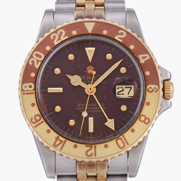 Rolex GMT-Master 'Root Beer', Reference 1675 | A stainless steel and yellow gold dual time zone wristwatch with date and bracelet | Circa 1979 · 1675