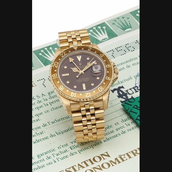 Rolex Rolex. A Fine and Attractive 18k Gold Automatic Dual-Time Wristwatch with Brown Dial, Date, Bracelet and Original Certificate ROLEX, OYSTER PERPETUAL, GMT-MASTER, REF. 16758, CASE NO. 7'561'098, CIRCA 1986 · 16758
