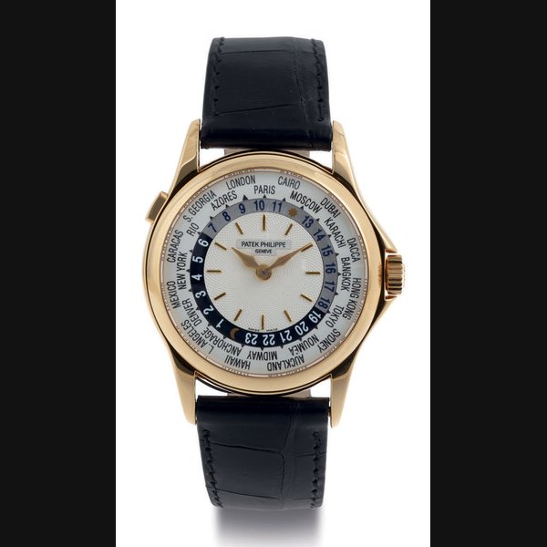 PATEK PHILIPPE. A FINE 18K GOLD AUTOMATIC WORLD TIME WRISTWATCH SIGNED PATEK PHILIPPE, GENEVE, MOVEMENT NO. 3208995, CASE NO. 4142443, REF. 5110, MANUFACTURED IN 2002