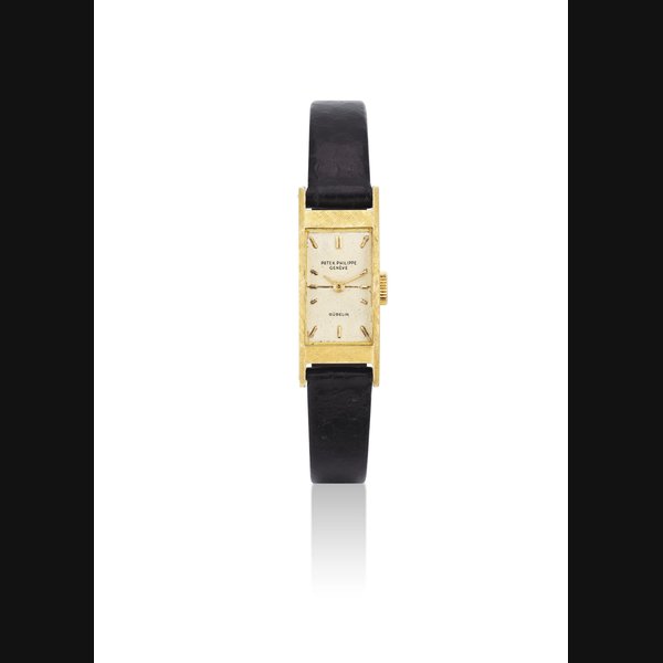 PATEK PHILIPPE. A LADY'S 18K GOLD RECTANGULAR WRISTWATCH SIGNED PATEK PHILIPPE, GENEVE, RETAILED BY GÜBELIN, REF, 2292, MOVEMENT NO. 843'637, CASE NO. 684'263, MANUFACTURED IN 1955