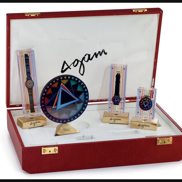 MOVADO. AN UNUSUAL AND LIMITED EDITION BLACK METAL AND POLYCHROME PRESENTATION SET COMPRISING A CLOCK, POCKET WATCH AND TWO WRISTWATCHES SIGNED MOVADO, LOVE STAR, COLLECTION TWO, AGAM SERIES, CLOCK, NO. 81/250, CASE NO. 87.10.802, POCKET WATCH 81/250, CASE NO. 84.29.511, THE FIRST WATCH 81/100, CASE NO. 84.40.889, THE SECOND 128/150, CASE NO. 87.40.888, CIRCA 1989
