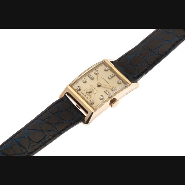 Longines Longines. A 14K gold manual wind wristwatch