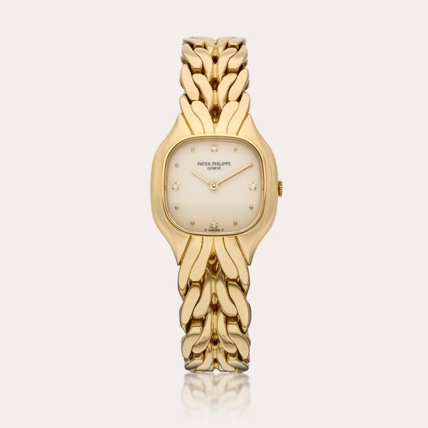 Patek Philippe Reference 4815/1 La Flamme | A yellow gold and diamond-set cushion-shaped wristwatch with bracelet, Circa 1992