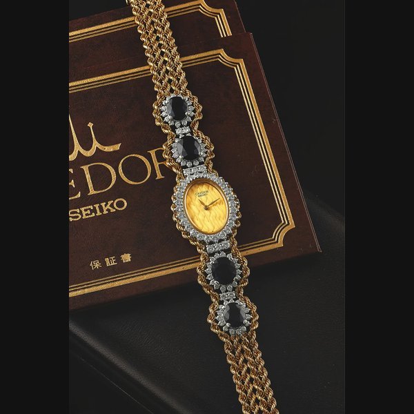 Seiko SEIKO REF. 8420 CREDOR YELLOW GOLD PLATINUM DIAMONDS & SAPPHIRES Seiko Credor, Ref. 8420-6290. Made in the 2000s. Fine, oval, 18K yellow gold, platinum, diamonds and sapphires quartz wristwatch with an integral 18K yellow gold woven rope bracelet with 4 platinum insets set with 64 round diamonds and 5 large sapphires. Accompanied by the original fitted box, guarantee and instruction booklet. | Important Modern and Vintage Timepieces | New York, 10th April 2013 · 8420