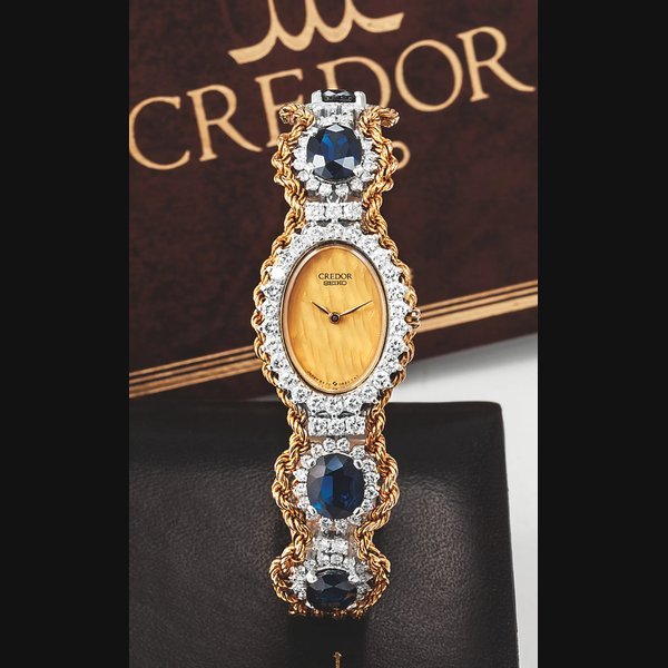 Seiko SEIKO REF. 8420 CREDOR YELLOW GOLD PLATINUM DIAMONDS & SAPPHIRES Seiko Credor, Ref. 8420-6290. Made in the 2000s. Fine, oval, 18K yellow gold, platinum, diamonds and sapphires quartz wristwatch with an integral 18K yellow gold woven rope bracelet with 4 platinum insets set with 64 round diamonds and 5 large sapphires. Accompanied by the original fitted box, guarantee and instruction booklet. | Important Modern & Vintage Timepieces | Hong Kong, 22 June 2013 · 8420