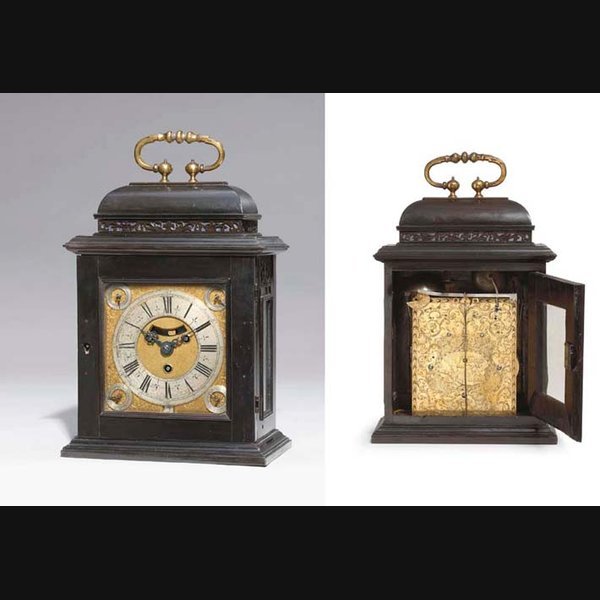 A small and rare Queen Anne ebony quarter striking table clock with calendar CLAUDIUS DE CHESNE, LONDON. CIRCA 1710
