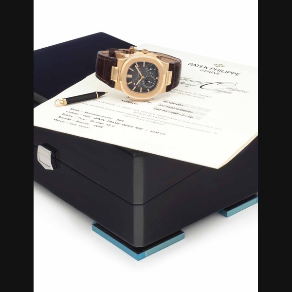 Patek Philippe. A Fine and Large 18k Pink Gold Automatic Wristwatch with Date, Moon Phases, and Power Reserve SIGNED PATEK PHILIPPE, GENÈVE, NAUTILUS MODEL, REF. 5712, MOVEMENT NO. 3'171'432, CASE NO. 4'396'567, MANUFACTURED IN 2007