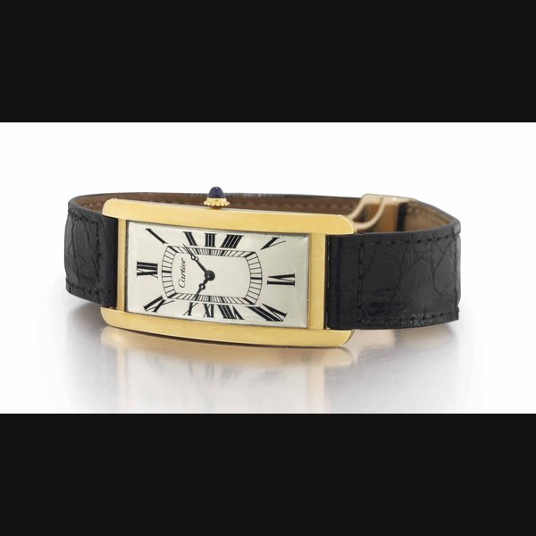 Cartier. A Rare and Oversized 18k Gold Rectangular Curved Wristwatch SIGNED CARTIER, GRANDE TANK CINTRÉE MODEL, CASE STAMPED 27'206, 19'333, 2748, & 3628, MOVEMENT SIGNED EUROPEAN WATCH & CLOCK CO. INC., MOVEMENT NO. 27'206, INSIDE CASE SIGNED EUROPEAN WATCH & CLOCK CO. INC., FRANCE, INSIDE CASE NO. 19'333, CIRCA 1940