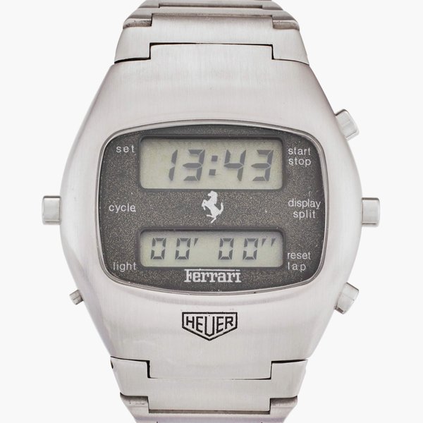 Heuer Reference R.102.703 Chronosplit 'Ferrari' | A stainless steel chronograph wristwatch with date, bracelet, and LCD display, Circa 1975, Price & Market Data
