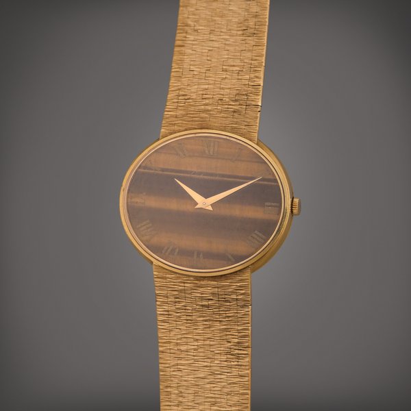 Piaget Reference 12501 A 6 | A yellow gold automatic oval bracelet watch with tiger's eye dial, Circa 1971