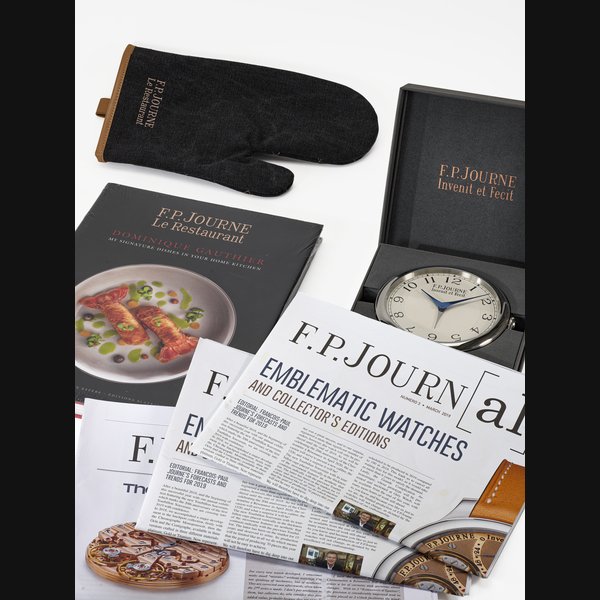 A SET OF TWO F.P. JOURNE ACCESSORIES ALARM DESK CLOCK 'SOUVERAINE' AND COOKING GLOVE 'LE RESTAURANT'
