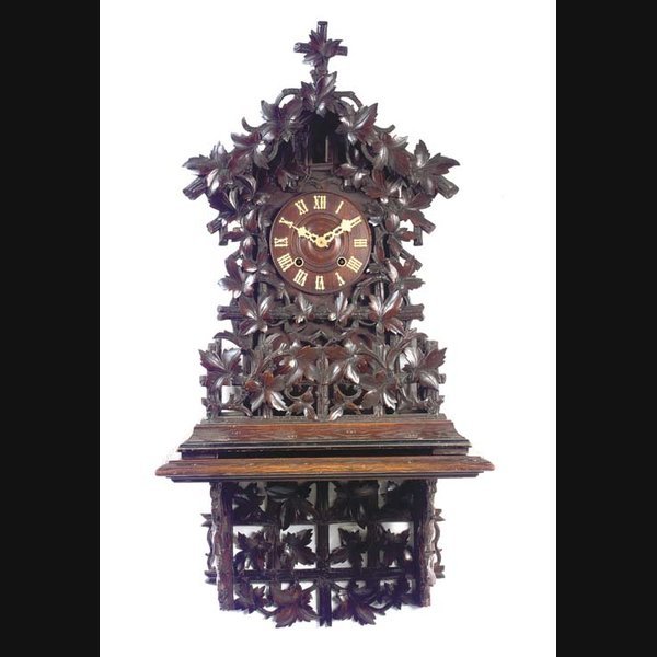 A Black Forest carved and stained wood cuckoo bracket clock on wall bracket, last quarter 19th Century