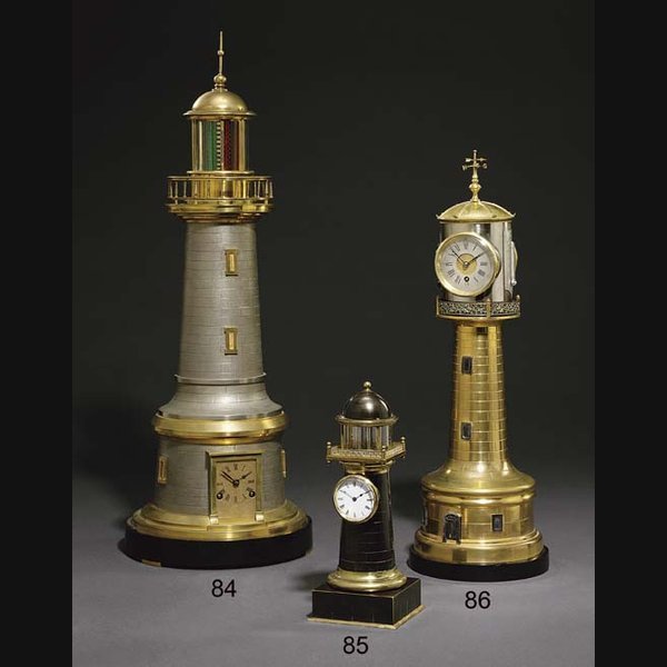 Lighthouse A French brass and silvered and black slate eight day timepiece with barometer, twin thermometers and automaton light CIRCA 1890