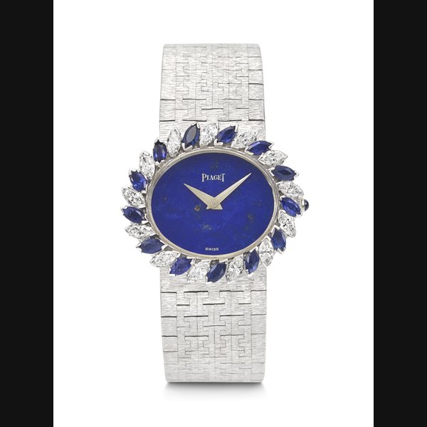 PIAGET. A STRIKING AND CHARMING 18K WHITE GOLD, DIAMOND AND BLUE SAPPHIRE-SET BRACELET WATCH WITH LAPIS LAZULI DIAL REF. 93929 A6, MOVEMENT NO. 715'397, CASE NO. 136'893, 67, MANUFACTURED IN 1967