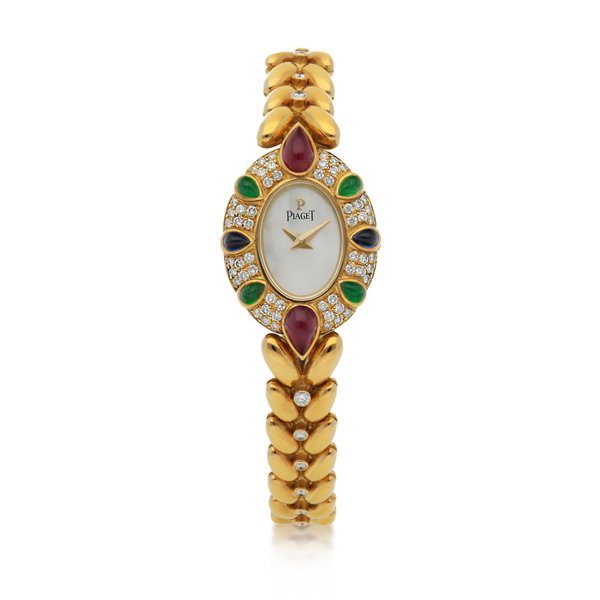 Piaget REF 8510 E104 YELLOW GOLD DIAMOND, SAPPHIRE, RUBY AND EMERALD-SET BRACELET WATCH WITH MOTHER-OF-PEARL DIAL CIRCA 1994 · 8510