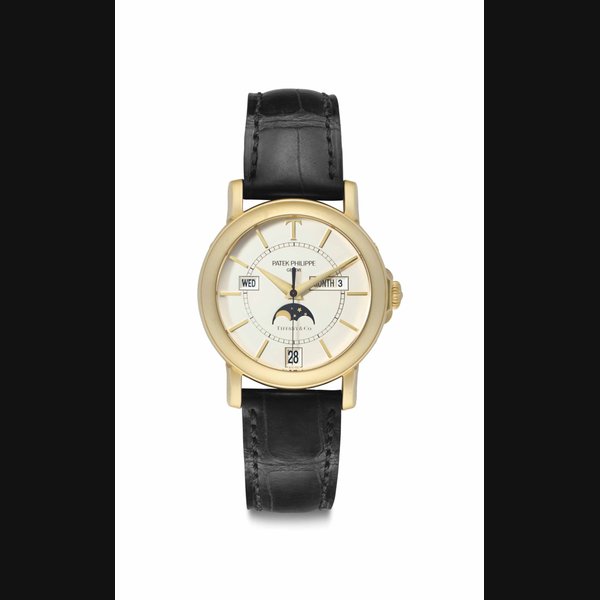 Patek Philippe. A Limited Edition Fine and Rare 18k Gold Annual Calendar Automatic Wristwatch with Center Seconds and Moon Phases Signed Patek Philippe, Genève, retailed by Tiffany & Co., Ref. 5150J, Movement No. 3’235’125, Case No. 4’162’191, Manufactured in 2001