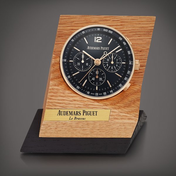 Audemars Piguet Code 11.59 | A metal work alarm desk clock with wooden stand, Circa 2021 | 愛彼 | Code 11.59 | 金屬鬧鐘，備木製展示座，約2021年製
