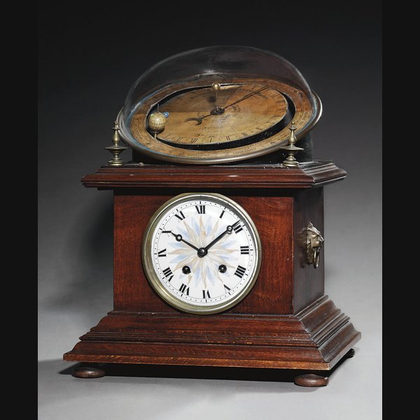 A Continental stained pine calendrical and astronomical striking eight day table clock with mechanical orrery LATE 19TH CENTURY