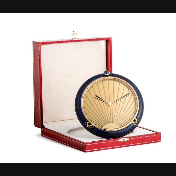 Cartier Cartier. A round gilt and blue lacquer quartz timepiece with box and paper No.52350, Sold 24 August 1991