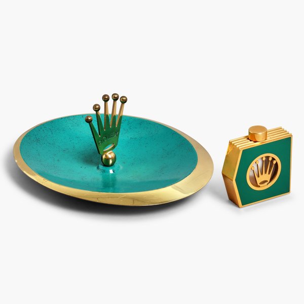Rolex A group of accessories comprising a brass painted ashtray and an enameled brass and crystal perfume bottle, Circa 1980s