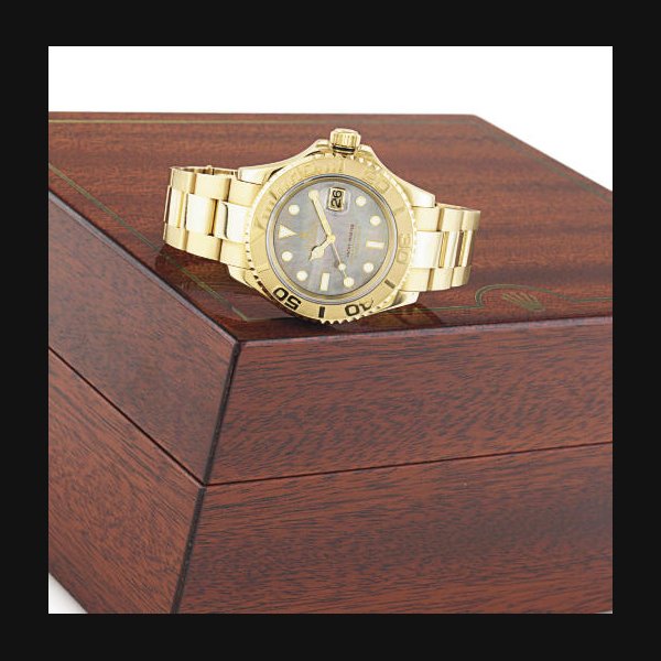 ROLEX. A FINE AND HEAVY 18K GOLD AND MOTHER-OF-PEARL AUTOMATIC WRISTWATCH WITH CENTER SECONDS, DATE AND BRACELET SIGNED ROLEX, OYSTER PERPETUAL DATE, "YACHTMASTER", CASE NO. Y172868, REF. 16628, CIRCA 2003