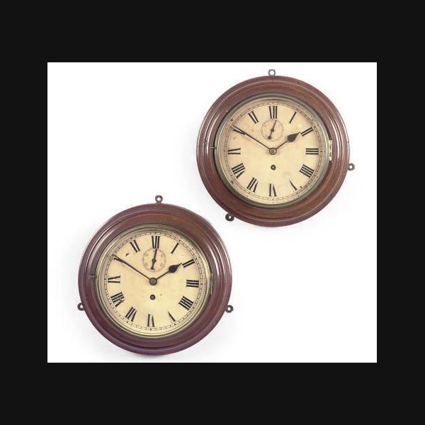 A pair of English mahogany eight day timepiece bulkhead clocks FIRST HALF 20TH CENTURY