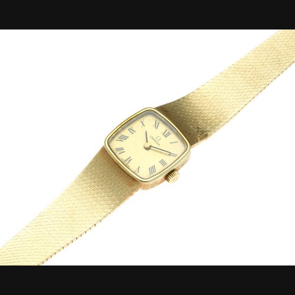 Omega Omega. A lady's 14K gold manual wind bracelet watch