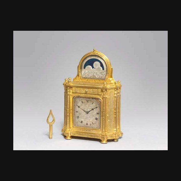 A Victorian engraved gilt-brass desk timepiece with moonphase, in the form of a miniature sideboard THOMAS COLE, LONDON, NO. 1018 3. CIRCA 1855