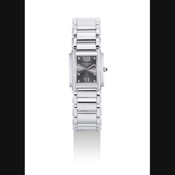 PATEK PHILIPPE. A LADY'S STAINLESS STEEL AND DIAMOND-SET RECTANGULAR WRISTWATCH WITH BRACELET SIGNED PATEK PHILIPPE, GENEVE, TWENTY~4 MODEL, REF. 4910, MOVEMENT NO. 1'673'053, CASE NO. 4'149'691, CIRCA 2001