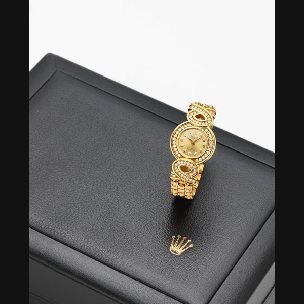 Rolex Rolex. A lady's 18K gold and diamond set manual wind bracelet watch with box and papers Cellini, Ref:5218-8, Serial No.W042***, Sold 19th December 1997 · 5218-8