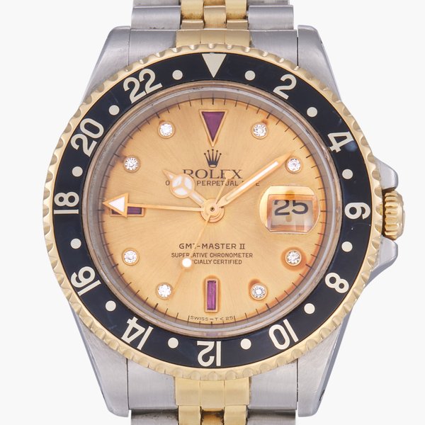 Rolex GMT-Master II, Reference 16713 | A stainless steel and yellow gold dual time zone wristwatch with date, bracelet and ruby and diamond-set dial | Circa 1991