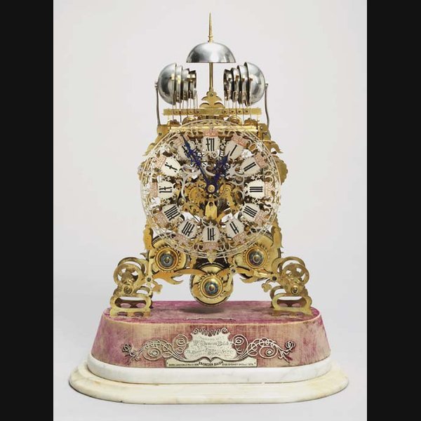 A Victorian brass and white marble quarter-chiming presentation skeleton clock SMITH & SONS, LONDON. CIRCA 1869