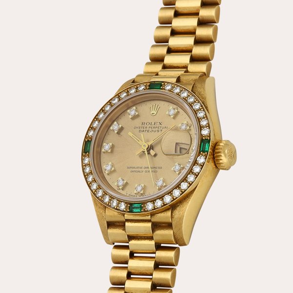 Rolex Lady Datejust, Reference 69078 | A yellow gold, emerald- and diamond-set wristwatch with date and bracelet | Circa 1988