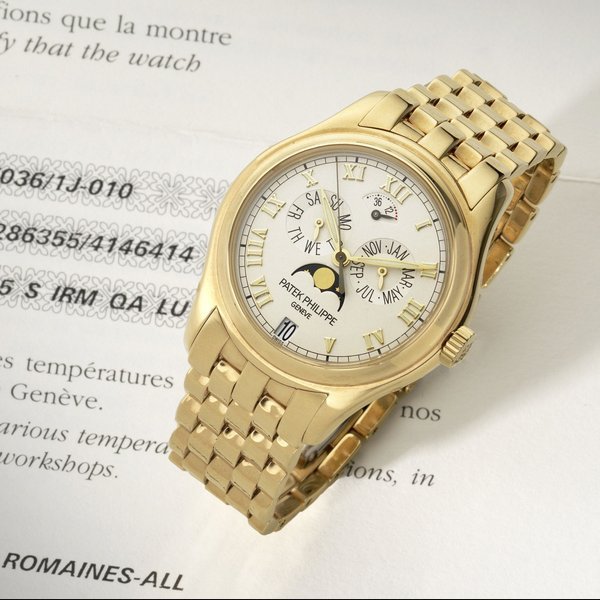 Patek Philippe Patek Philippe. A fine and rare 18ct gold automatic annual calendar bracelet watch with moon phase and 48 hour power reserve Ref:5036/1J-010, Case No.4146414, Movement No.3286355, Sold 25th December 2002 · 5036/1J-010
