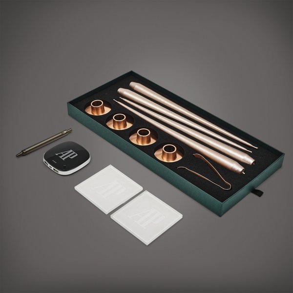 Audemars Piguet A set of four Christmas candles, ballpoint pen, power bank and two coasters, Circa 2020 | 愛彼 | 一套四件聖誕蠟燭、圓珠筆、攜帶式充電器及兩件杯墊，約2020年製