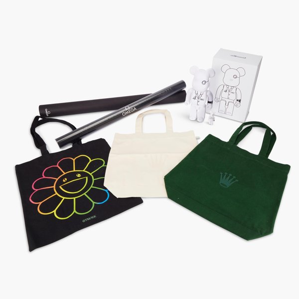 Rolex A set of two Rolex tote bags, two Rolex notebooks, two Rolex GMT-Master commemorative pen sets by Caran d’Ache, two Rolex three-watch travelling pouches, two Rolex scarfs, one pair of Audemars Piguet gloves by Marzi, one Audemars Piguet cardholder, one Audemars Piguet speaker, one Audemars Piguet 150th Anniversary pin set, one Audemars Piguet candle, one Cartier candle, two Cartier playing card sets, one Parmigiani Fleurier passport holder, one Parmigiani Fleurier card holder, two Tudor notebooks by Moleski