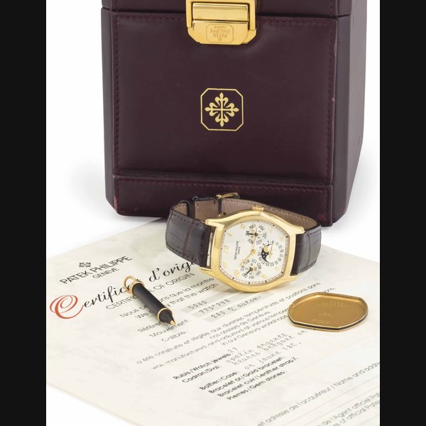 Patek Philippe. A Fine and Rare 18k Gold Automatic Tonneau-Shaped Perpetual Calendar Wristwatch with Moon Phases, Breguet Numerals, Original Certificate, and Additional Hard Back SIGNED PATEK PHILIPPE, GENEVE, REF. 5040, MOVEMENT NO. 773'798, CASE NO. 2'930'631, MANUFACTURED IN 1993