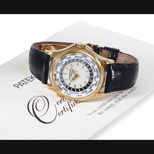 PATEK PHILIPPE. AN 18K GOLD AUTOMATIC WORLD TIME WRISTWATCH SIGNED PATEK PHILIPPE, GENEVE, MOVEMENT NO. 3209277, CASE NO. 4156023, REF. 5110, MANUFACTURED IN 2002