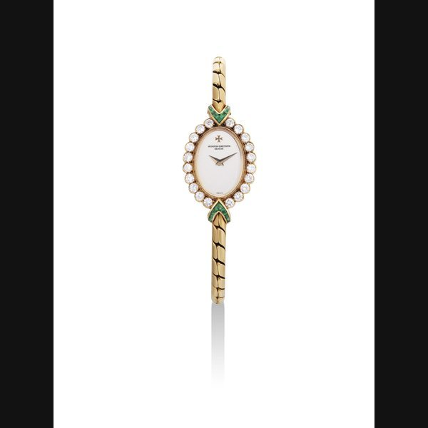 Vacheron Constantin VACHERON CONSTANTIN. A LADY'S FINE 18K GOLD, DIAMOND AND EMERALD-SET OVAL BRACELET WATCH SIGNED VACHERON CONSTANTIN, GENEVE, CASE NO. 561'770, CIRCA 1990